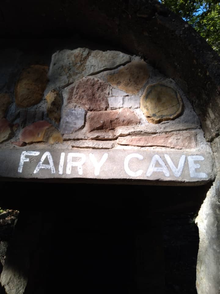 Fairy Cave sign over a stone doorway.
