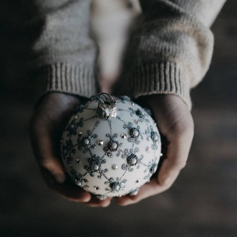 person holding bauble ball