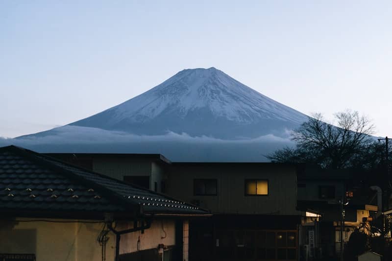 Snow-capped mount fuji looms over a quiet town.