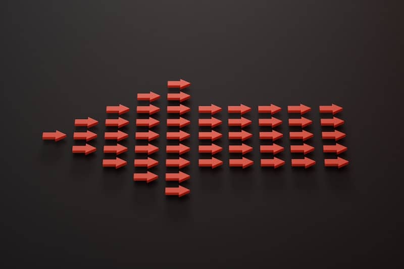 a group of red arrows on a black surface