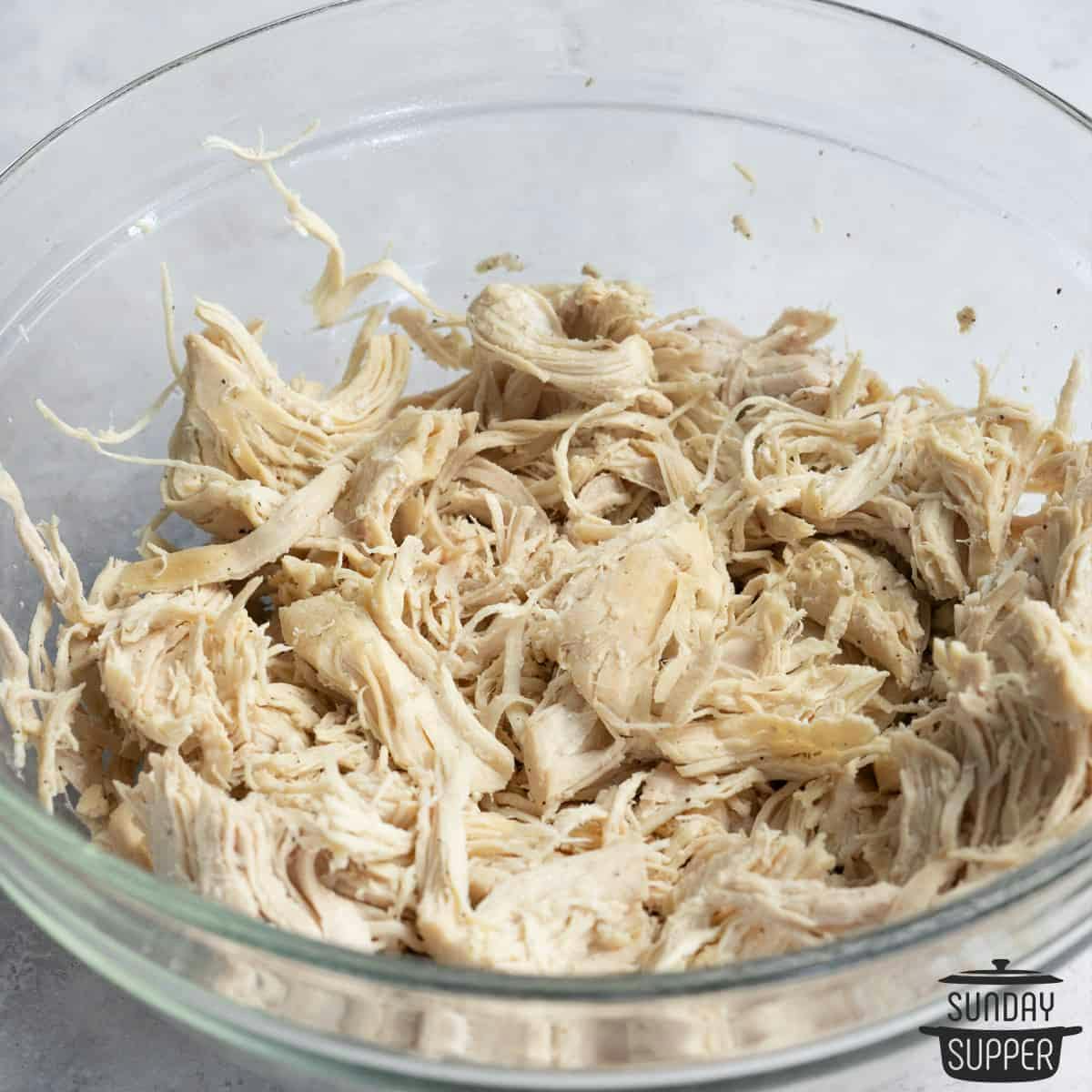 Shredded chicken in a glass bowl