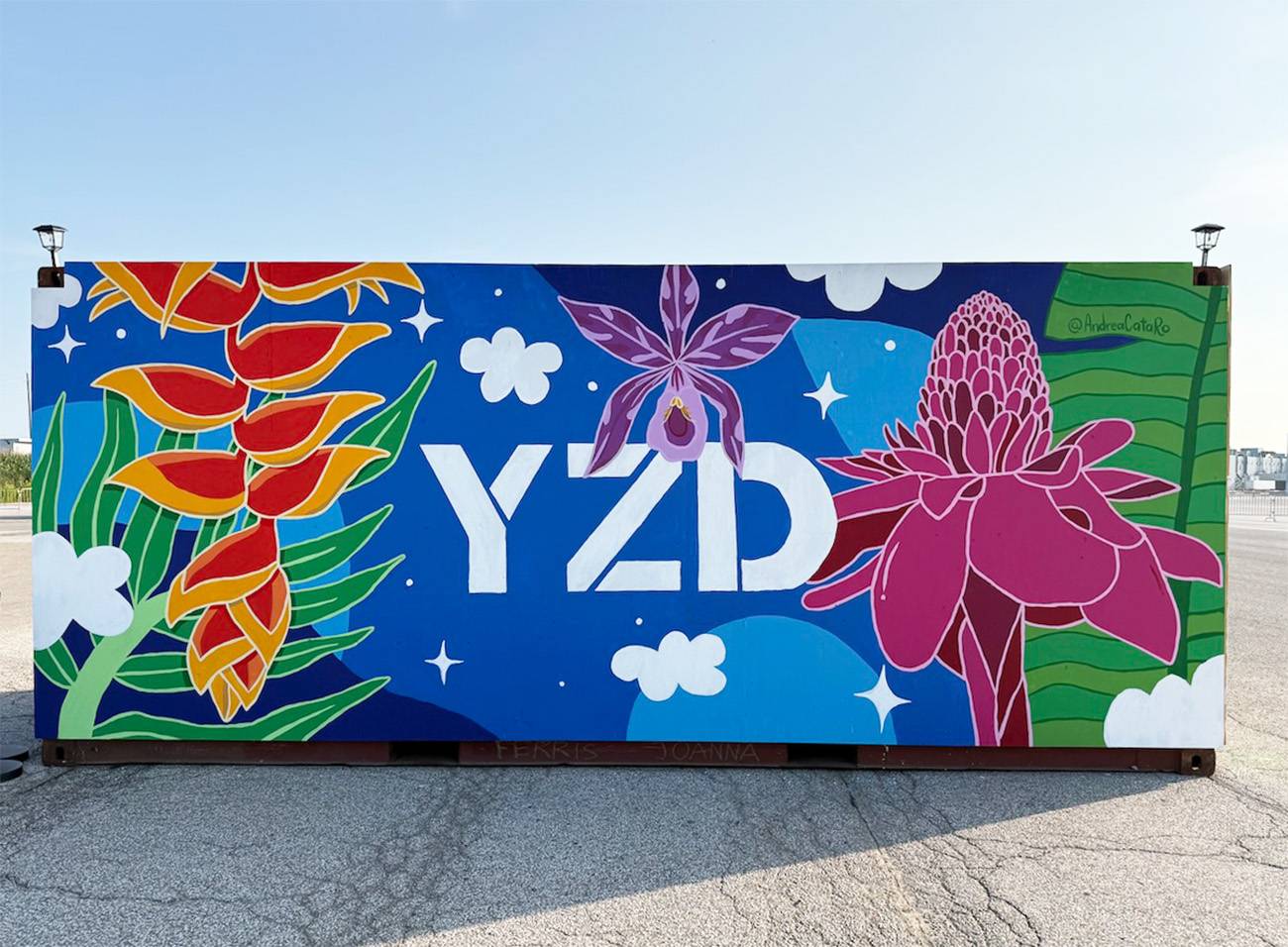 Mural work completed by Andreacataro, features tropical plants and the letters YZD