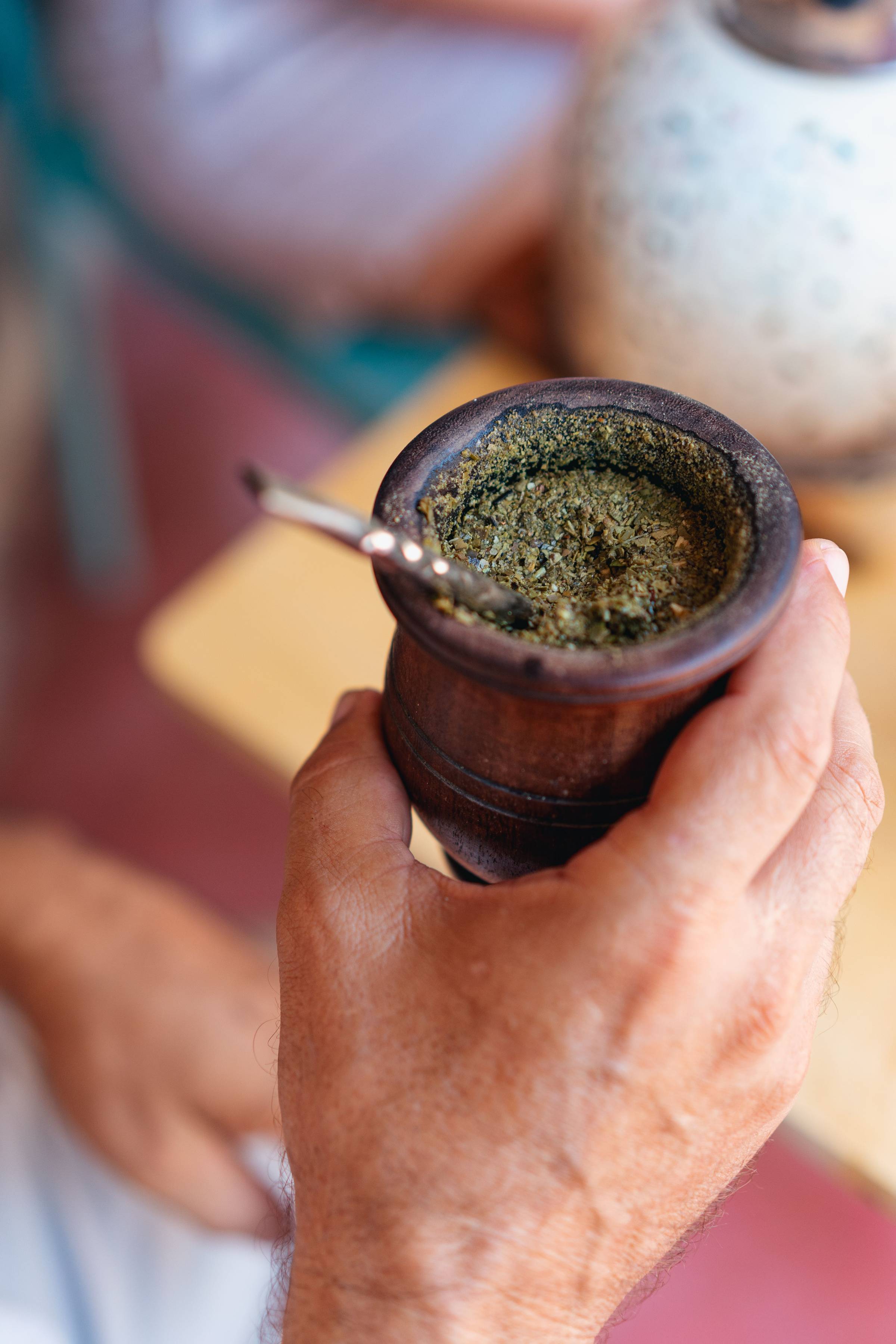 Traditional yerba mate drink in a metal cup with bombilla