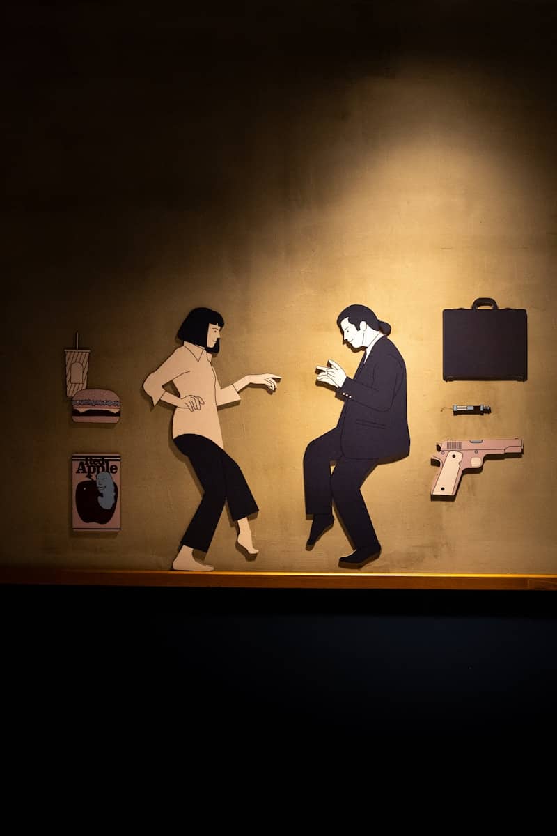 A couple of people that are standing in front of a wall