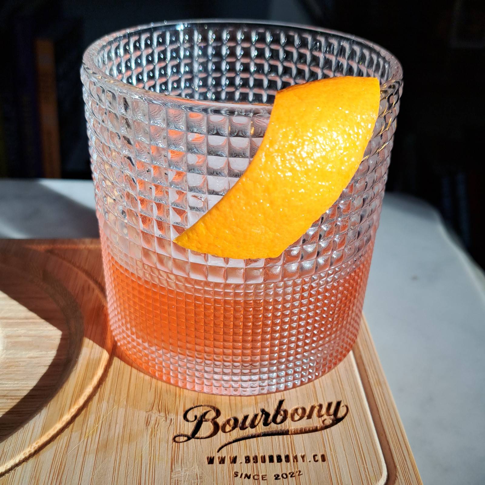 Blanc Slate Negroni riff with gin, Campari, Lillet Blanc, elderflower liqueur, and orange peel