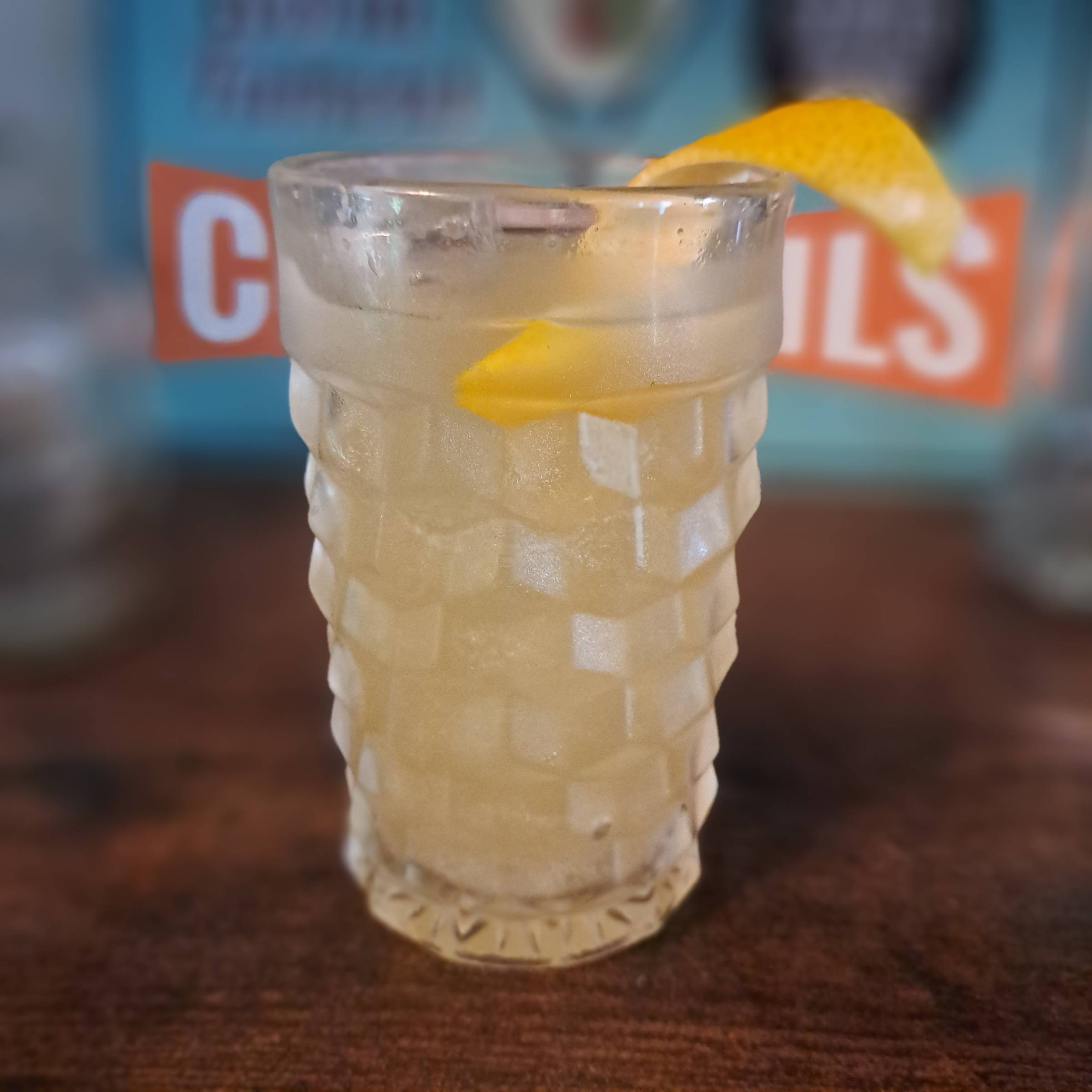 Rhinestone Wrangler bourbon cocktail with peach liqueur, chocolate mint, lemon, Angostura bitters, and ginger beer.