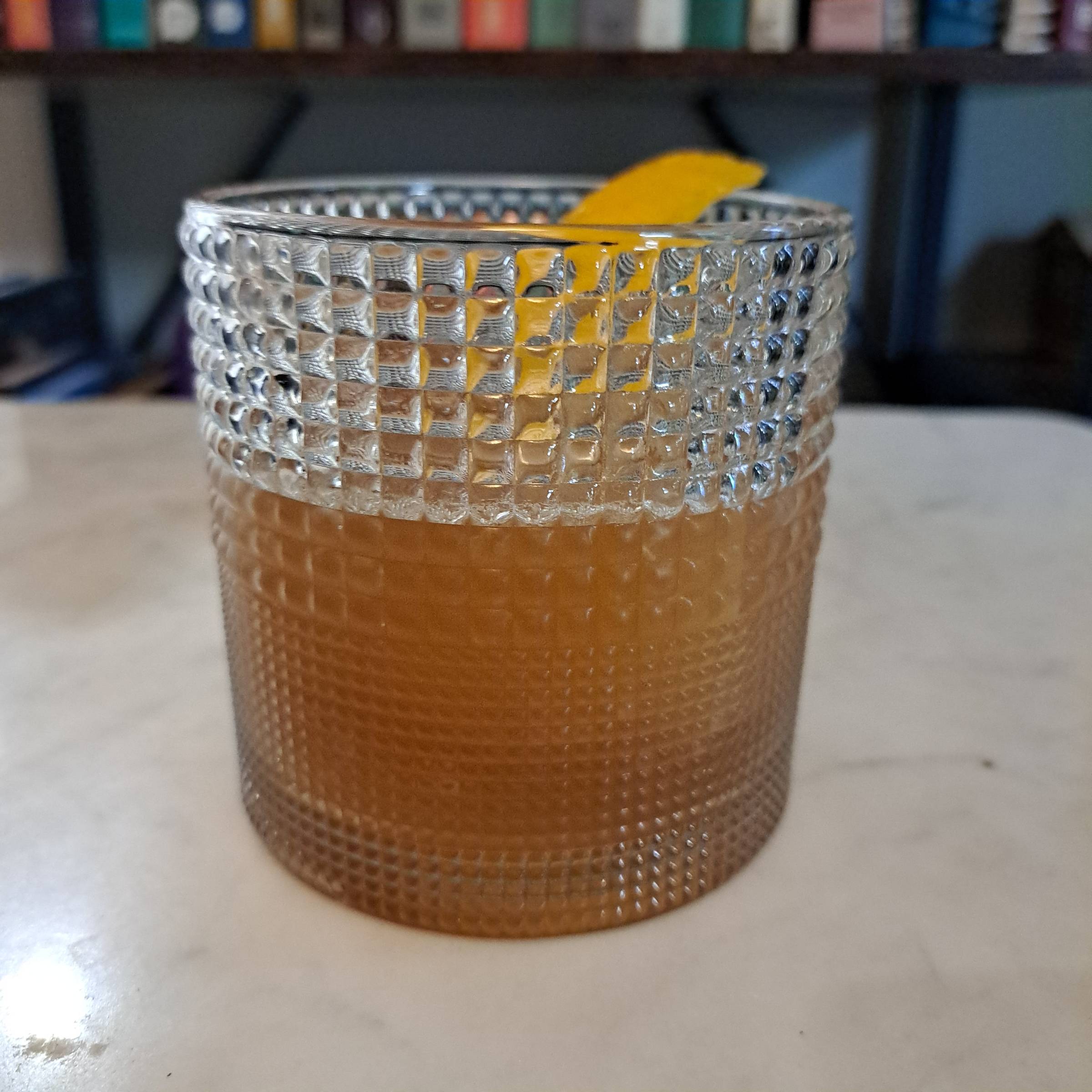 Peach Cardamom Whiskey Sour made with bourbon, peach liqueur, lemon and cardamom bitters