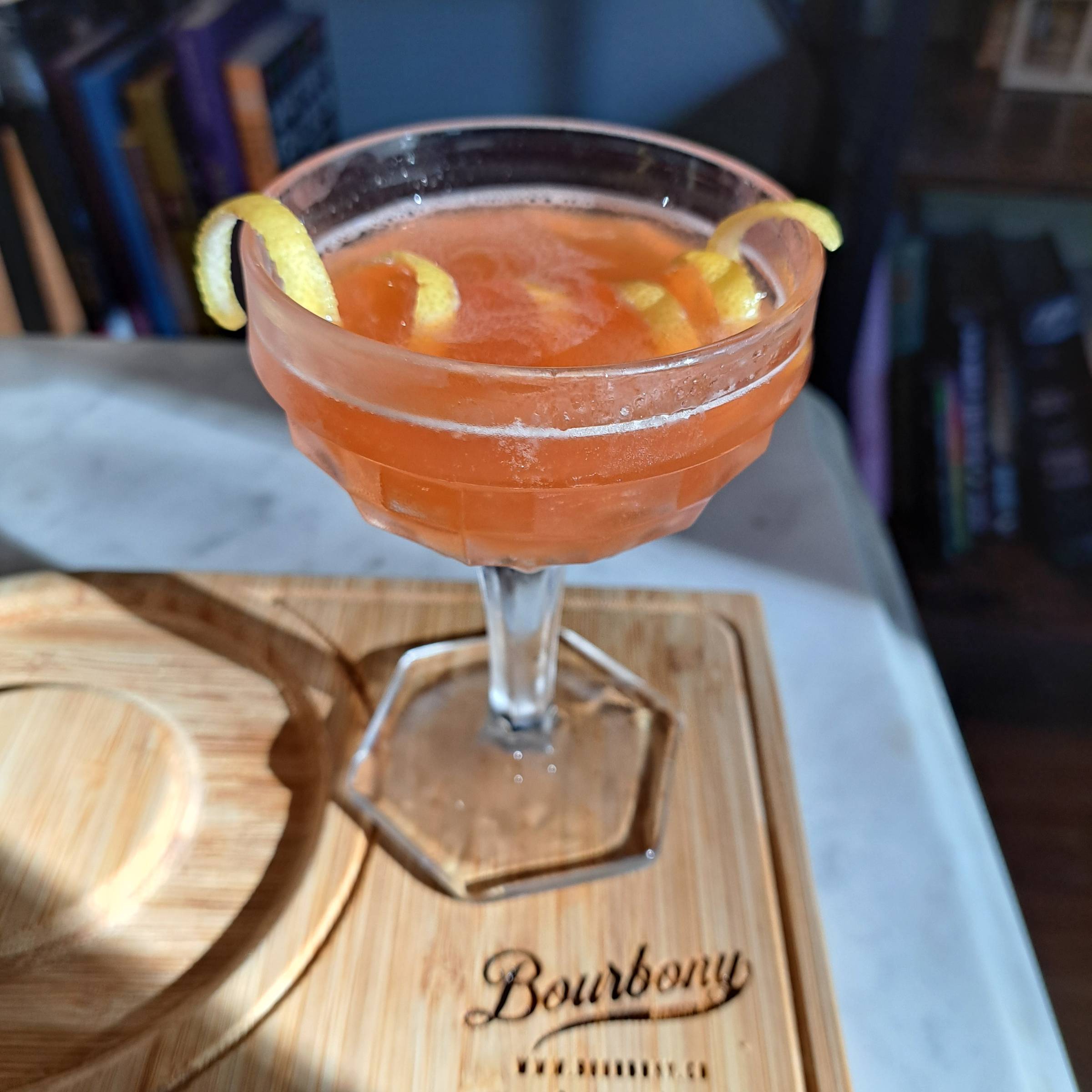 Paper Plane cocktail made with Wild Turkey 101 bourbon, Aperol, Amaro Montenegro, and fresh lemon juice.