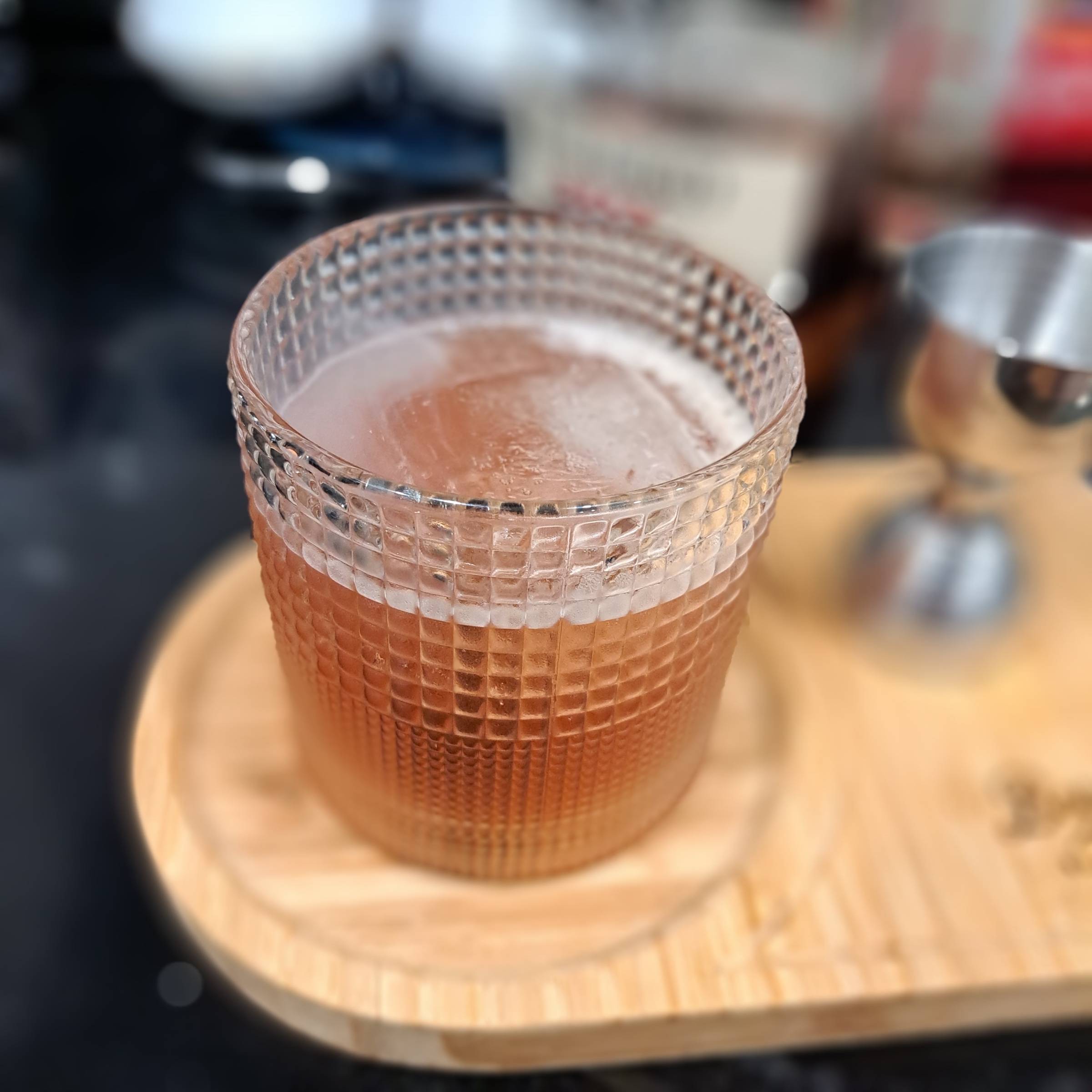 Smokin' Royal Flush bourbon cocktail with peach, raspberry, cranberry, and a brandied cherry garnish.
