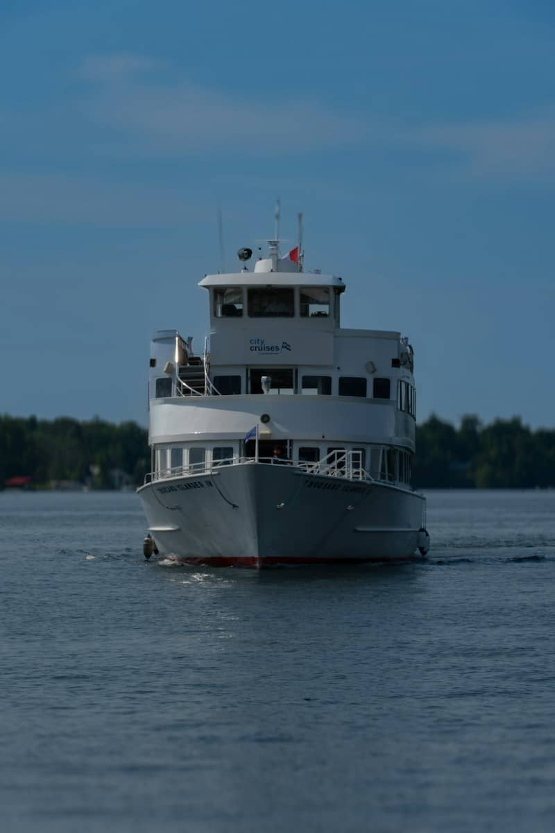 A ferryboat cruises across the calm water.