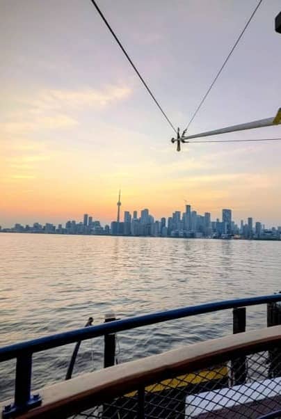 Toronto skyline from a boat at sunset.