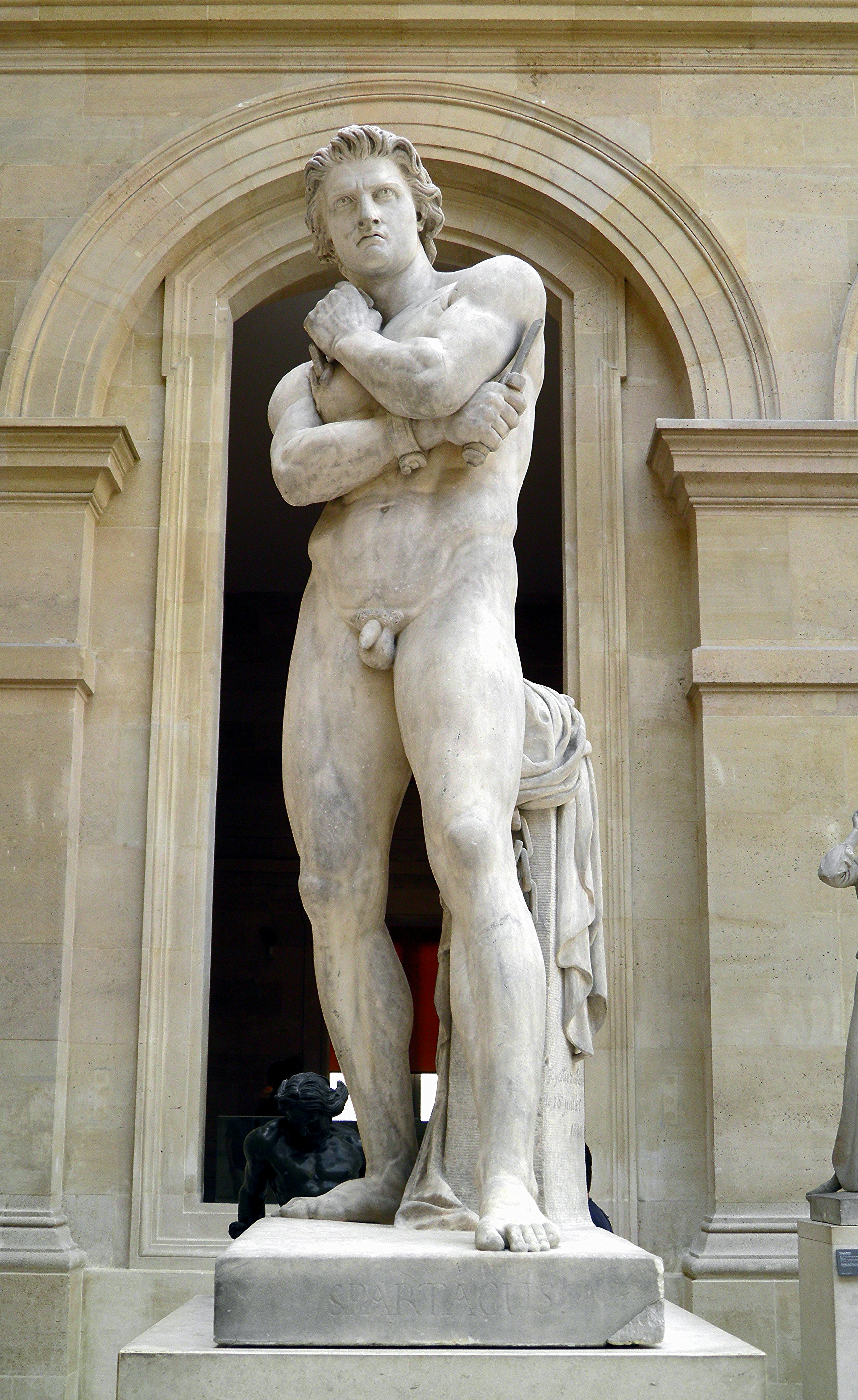 marble statue of naked male, standing with arms folded, dagger in one hand, looking stern and thoughtfully into the distance