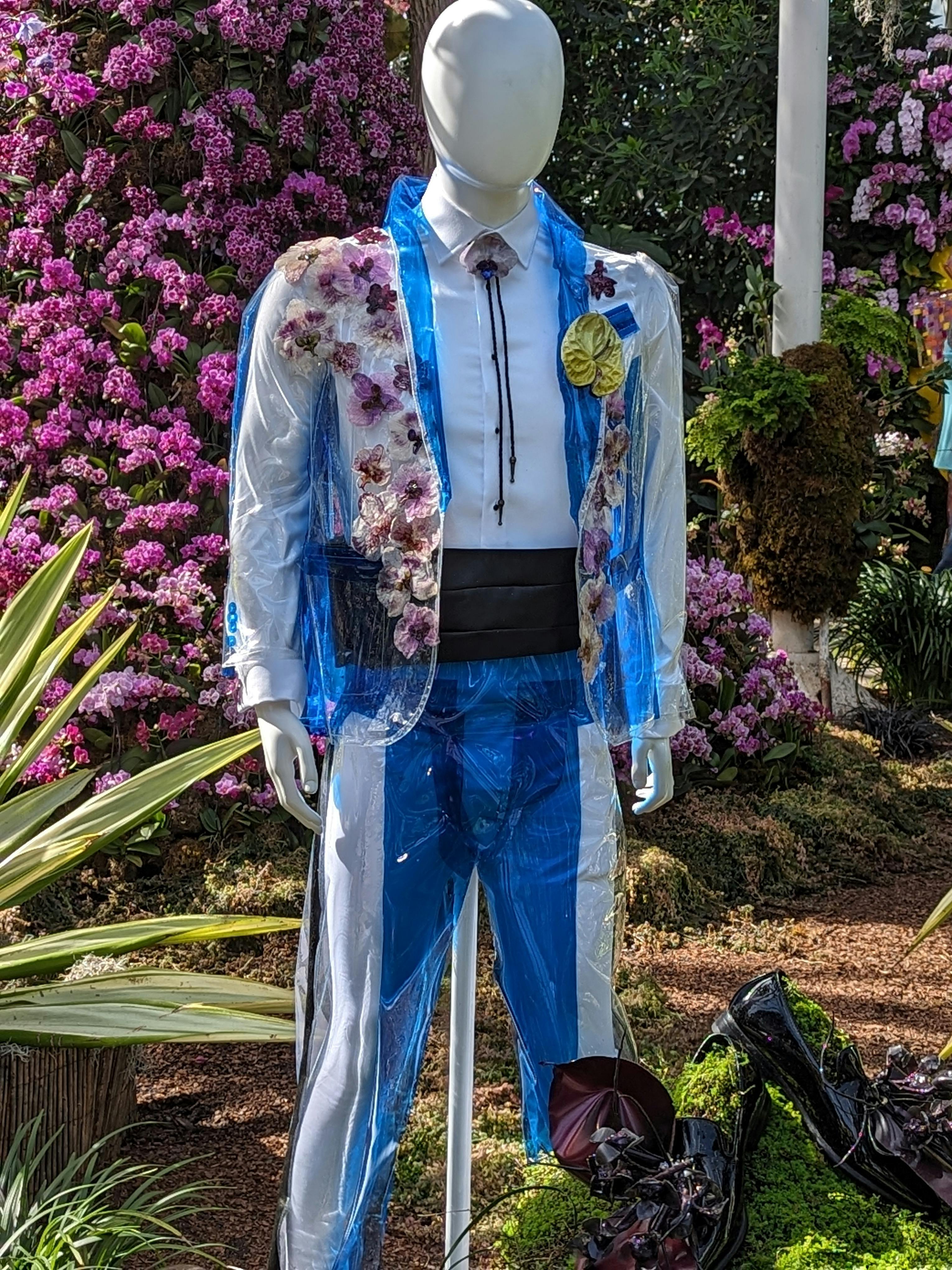 mannequin wearing plastic suite adorned with flowers