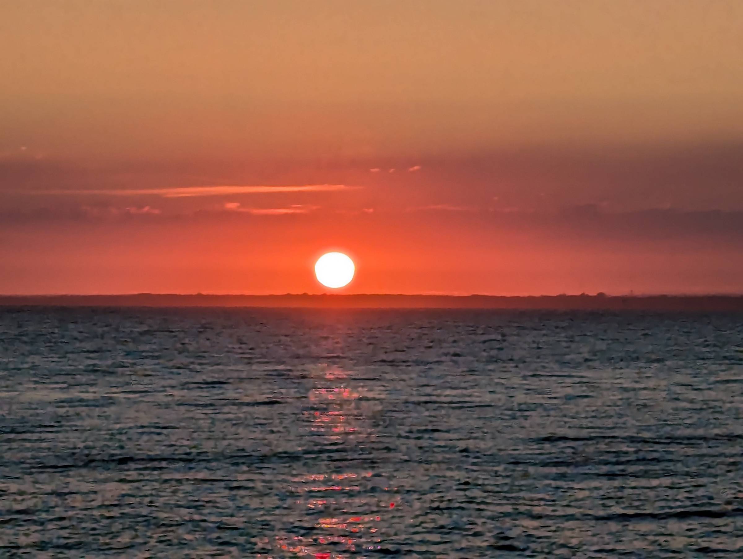fiery red, final moments of a sunset over the ocea