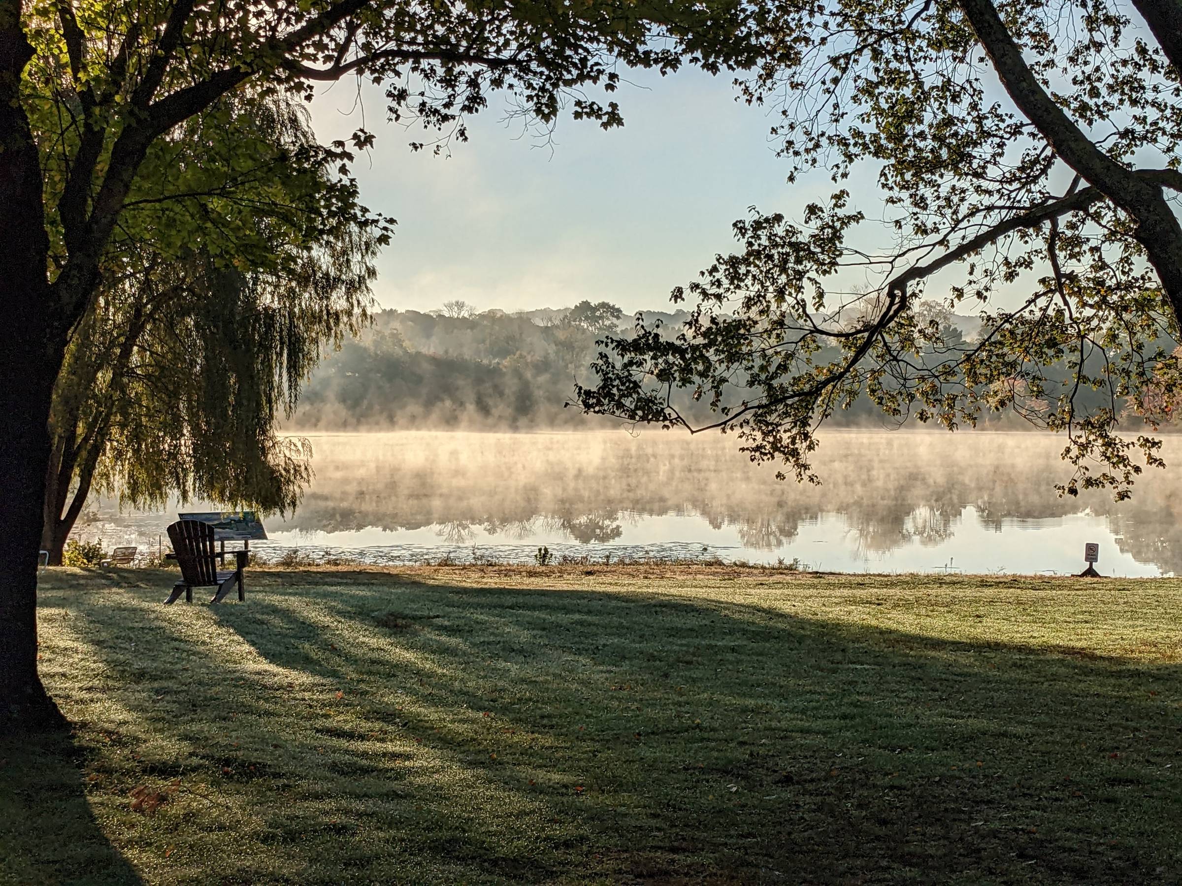 lake in the Hudson valley, at dawn, mist rising off the water