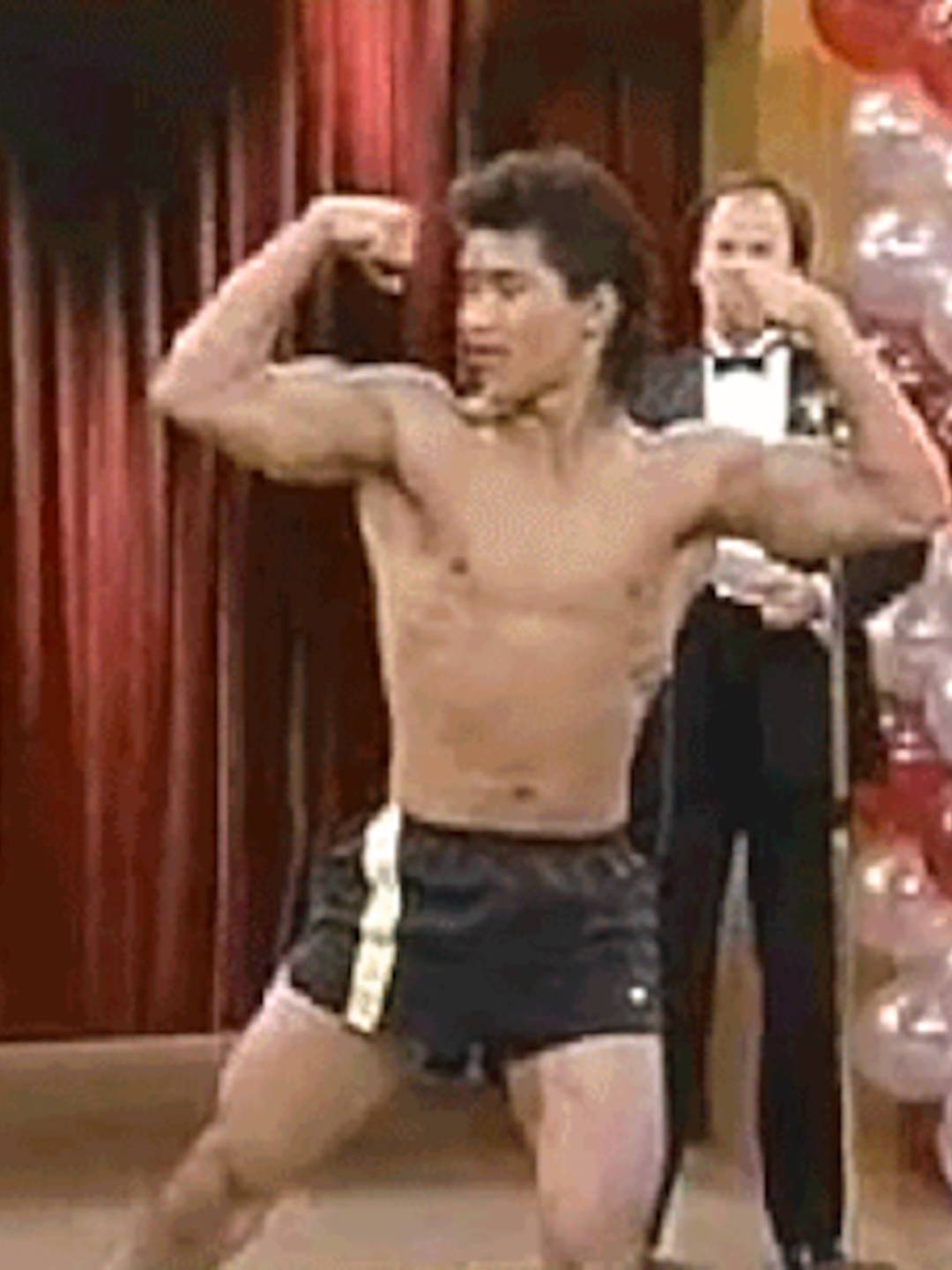 shirtless man doing double gun pose