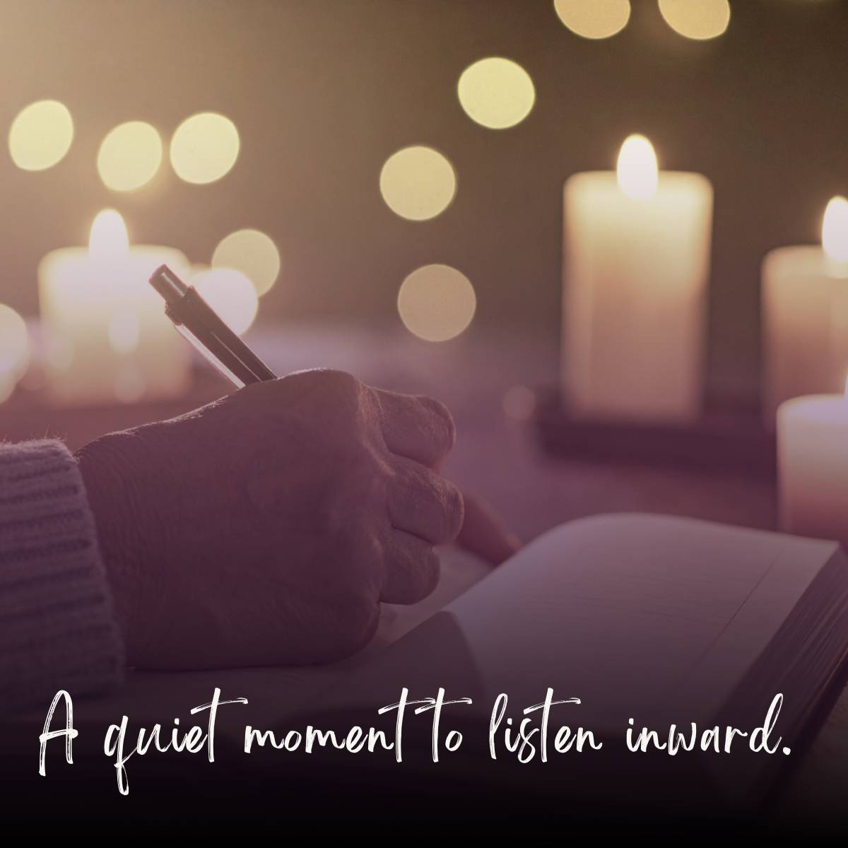 a woman sitting by candlelight, with pen in hand about to write in journal
