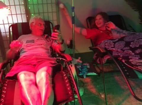 A man and a young girl getting Crohn's disease infusion IV therapy.