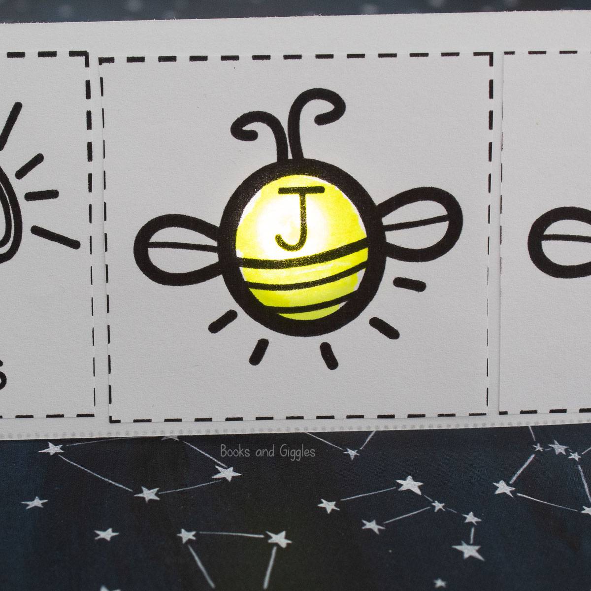 printable with a firefly with the letter J, lit from behind