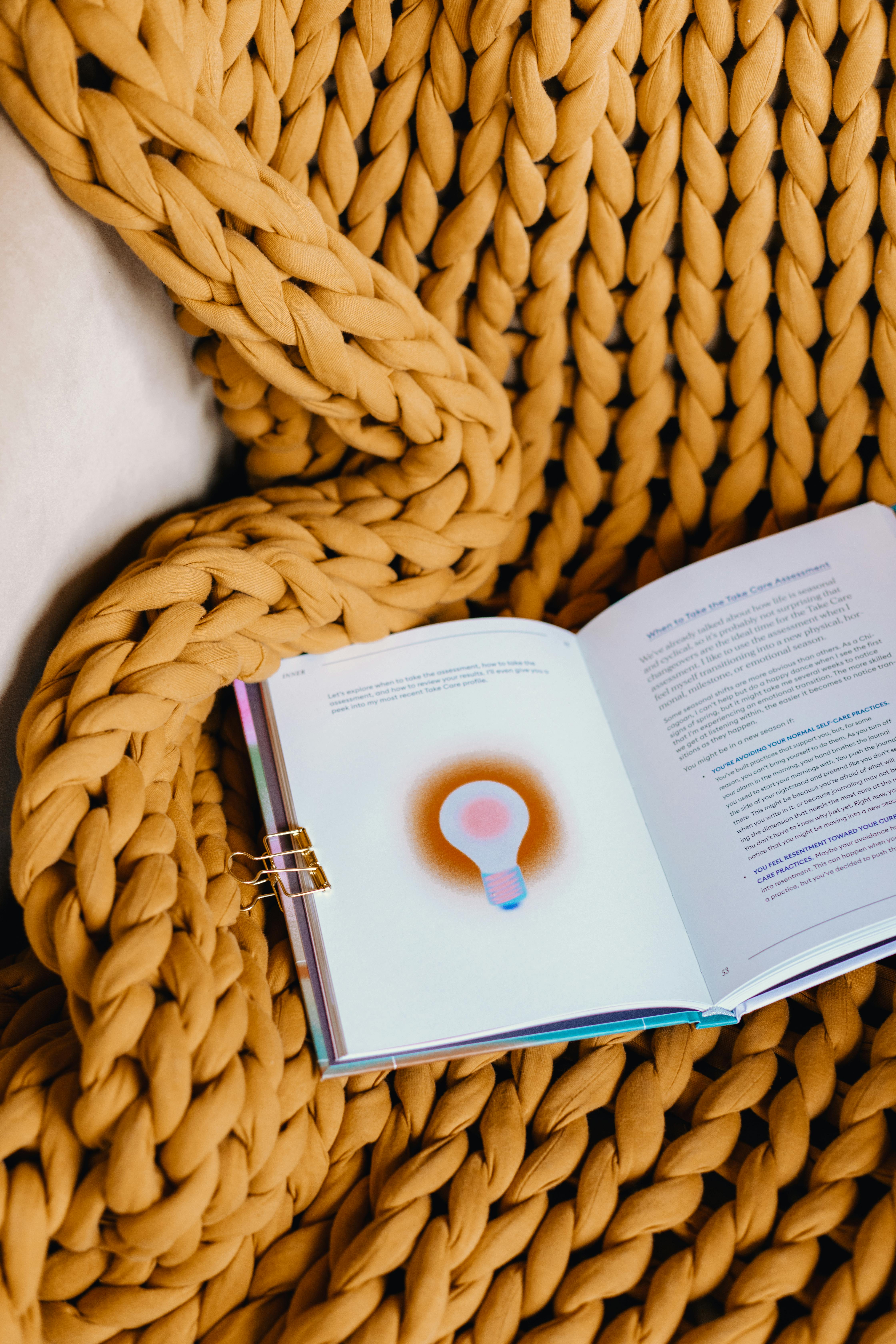 Inner Workout sits open on a yellow knitted blanket