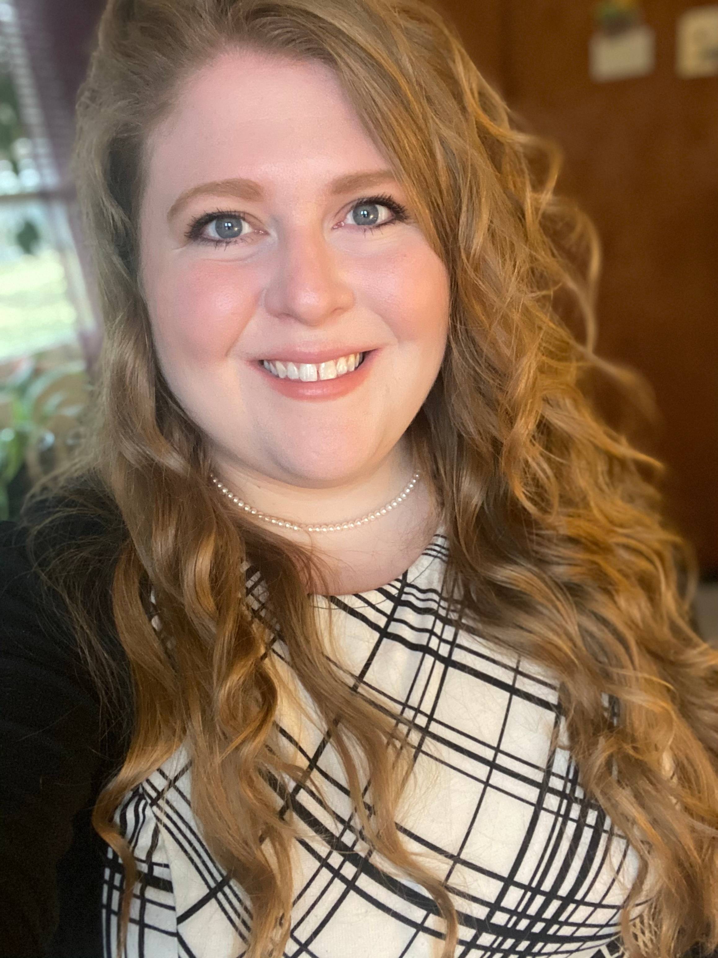 Lena Ziegler has long, wavy blonde hair. She is smiling at the camera.