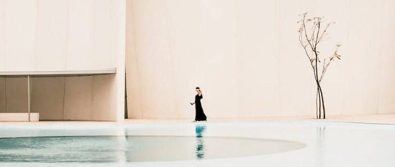 woman standing in front of white building