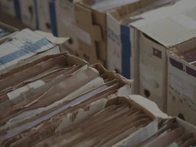 storage box, showing organized driver qualification files, vehicle maintenance logs, and commercial vehicle safety documents prepared for a compliance audit.