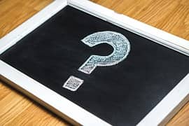 Image of a question mark drawn on a small chalkboard
