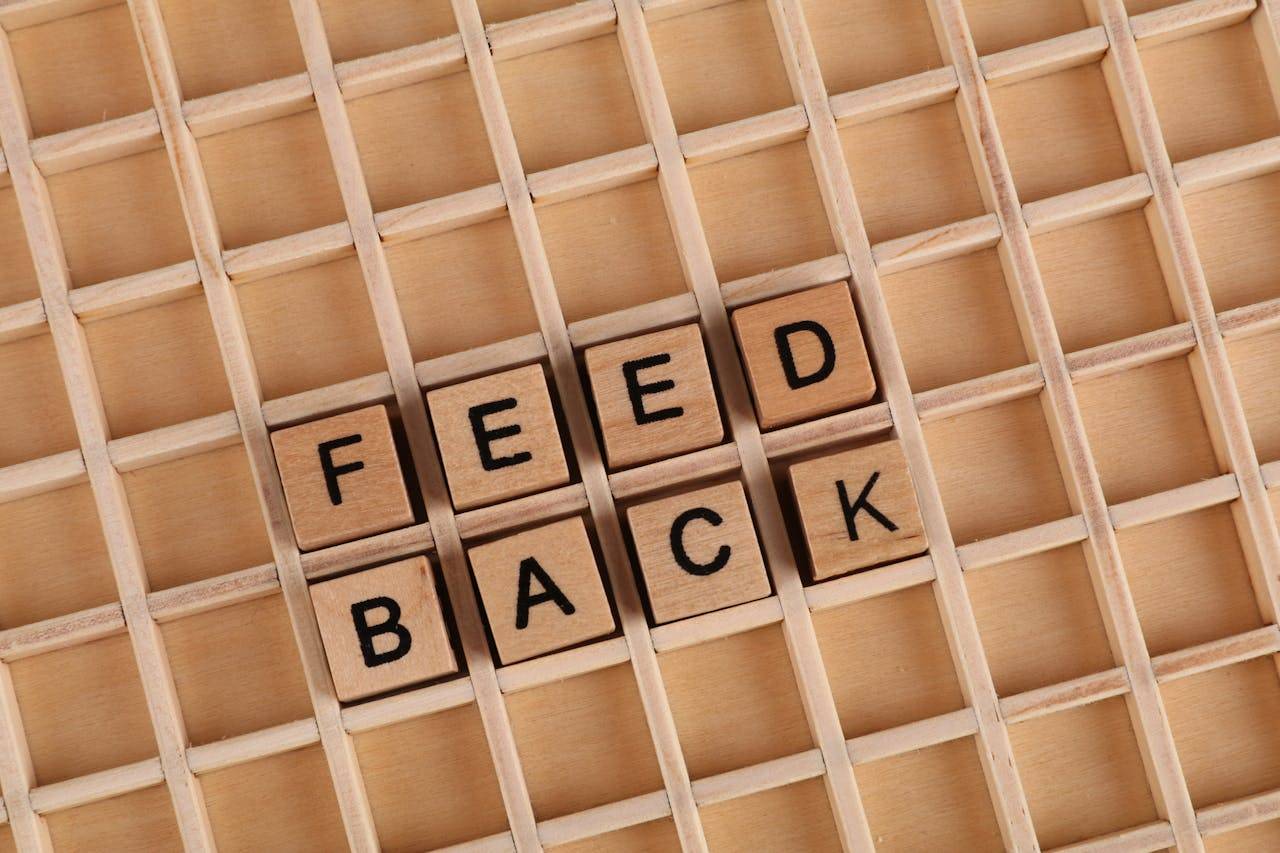 Wooden grid with blocks in the central squares spelling out feedback