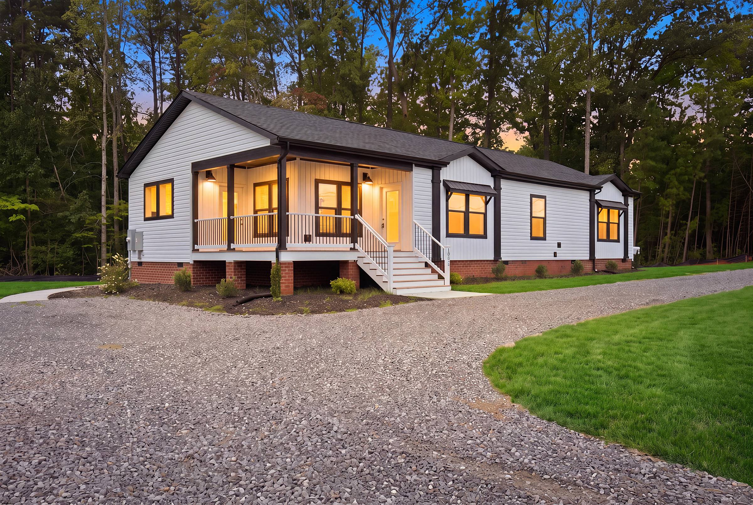 A new Clayton home listing in early evening with he lights glowing