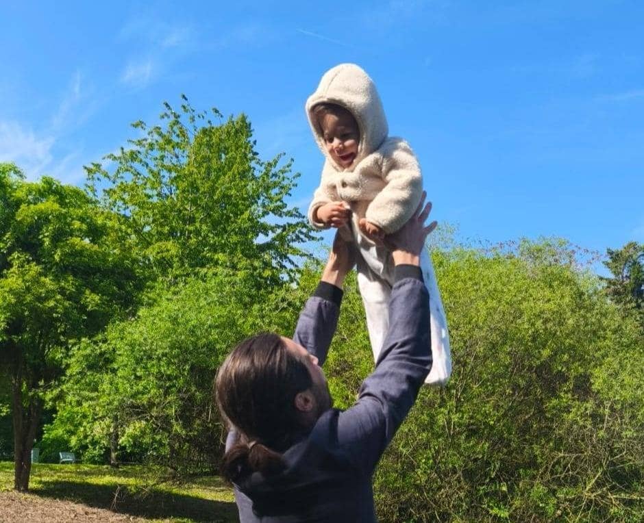 Cleo smiling while being thrown in the air by me