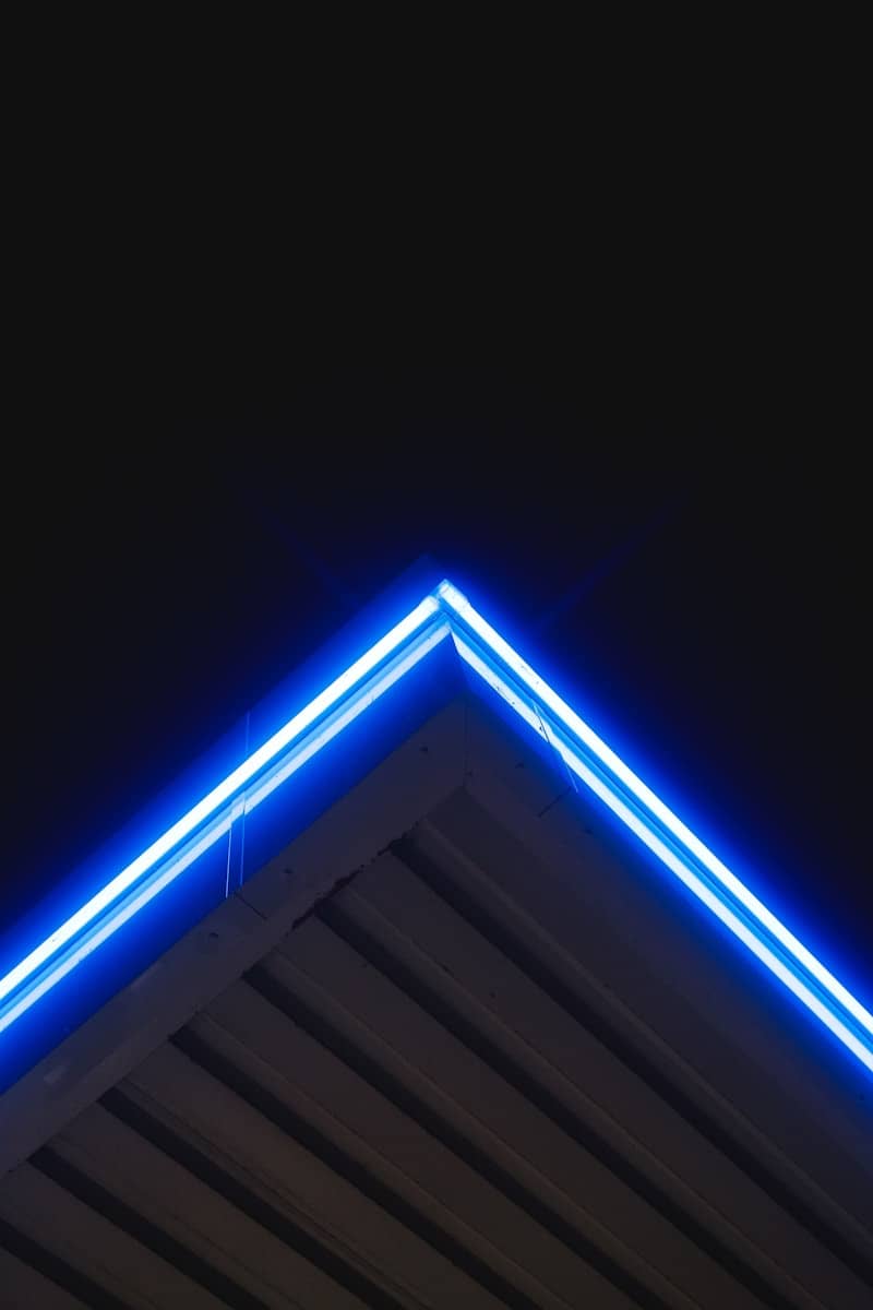 Blue neon lights illuminate an angled roof.