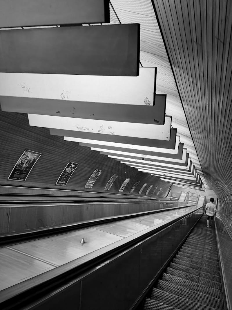 A person riding an escalator in a subway station