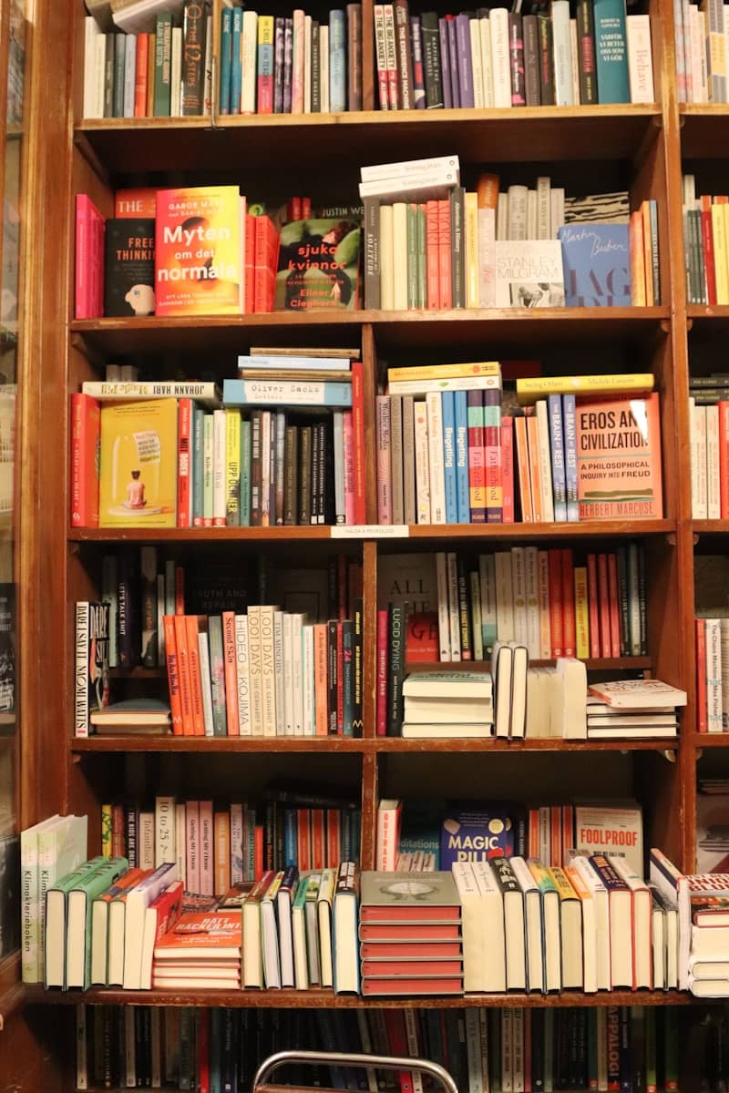 Bookshelves are overflowing with colorful books.