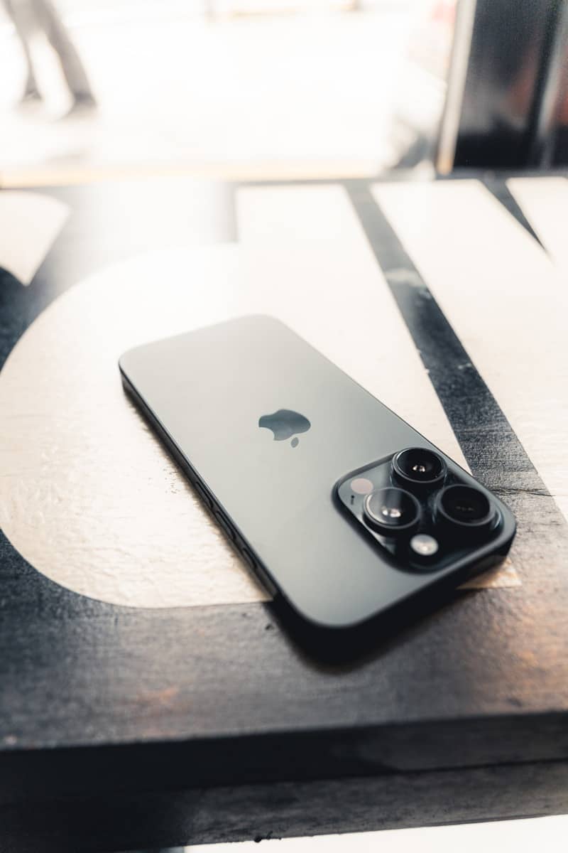 An iPhone rests on a patterned surface.