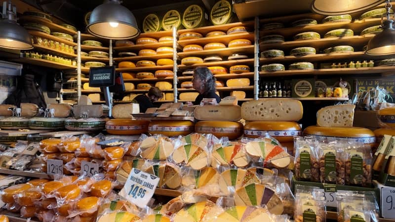 Display of various cheeses in a shop.