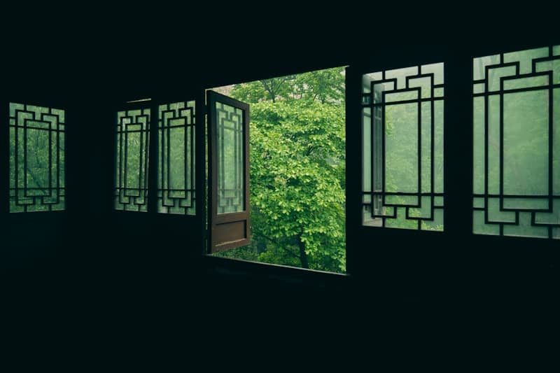 Windows reveal lush greenery and natural light.