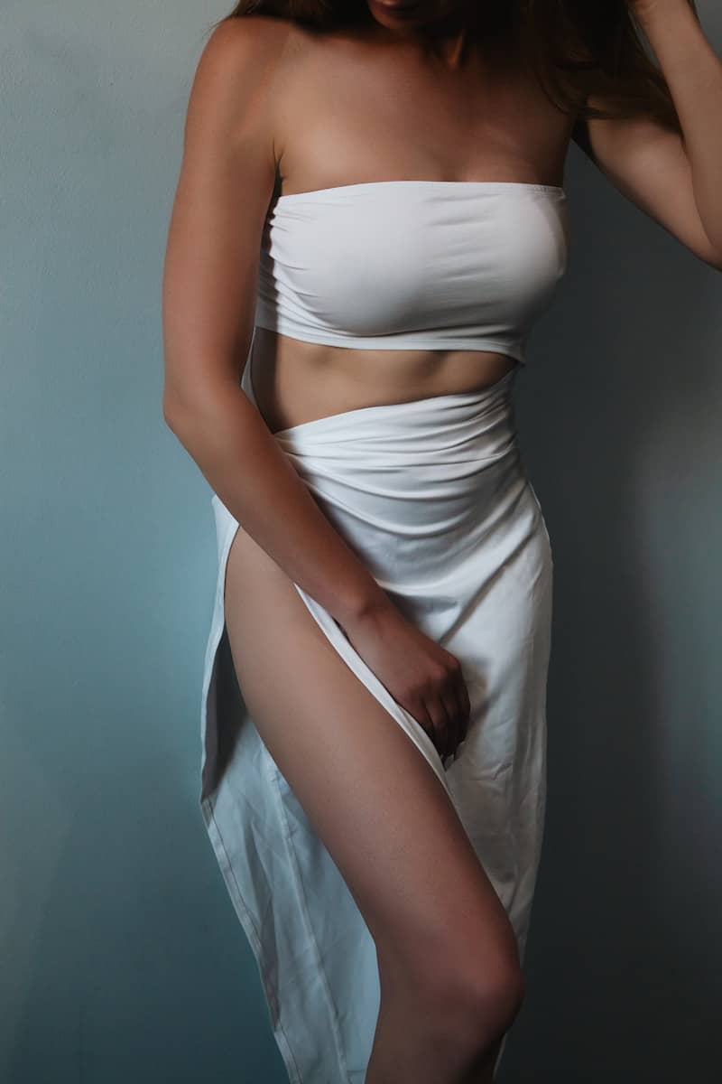 Woman in a white strapless dress with a high slit