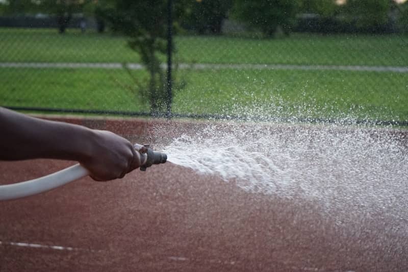 How can we measure the amount of water flowing through a hose?