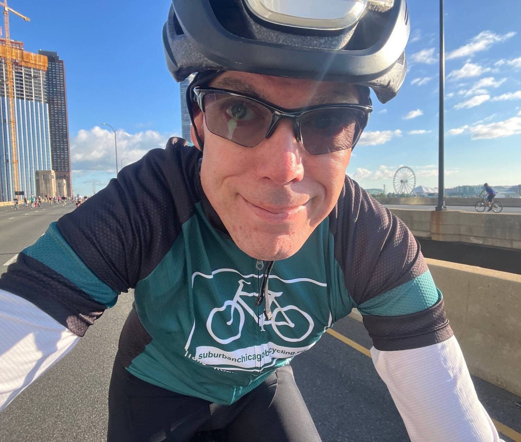 A cyclist takes a selfie on a city street