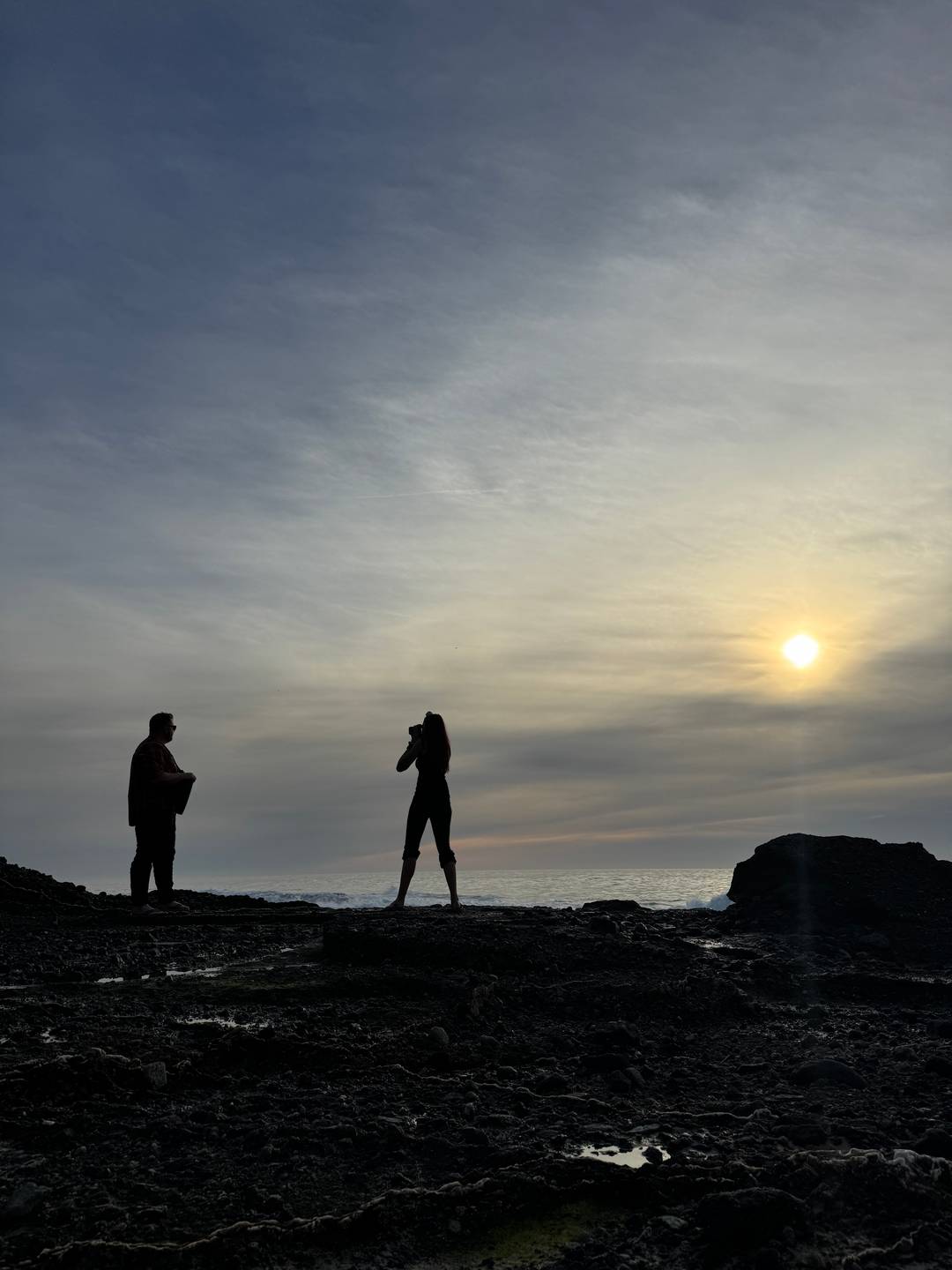 an image of a photographer capturing a professional image of a musician on the beach