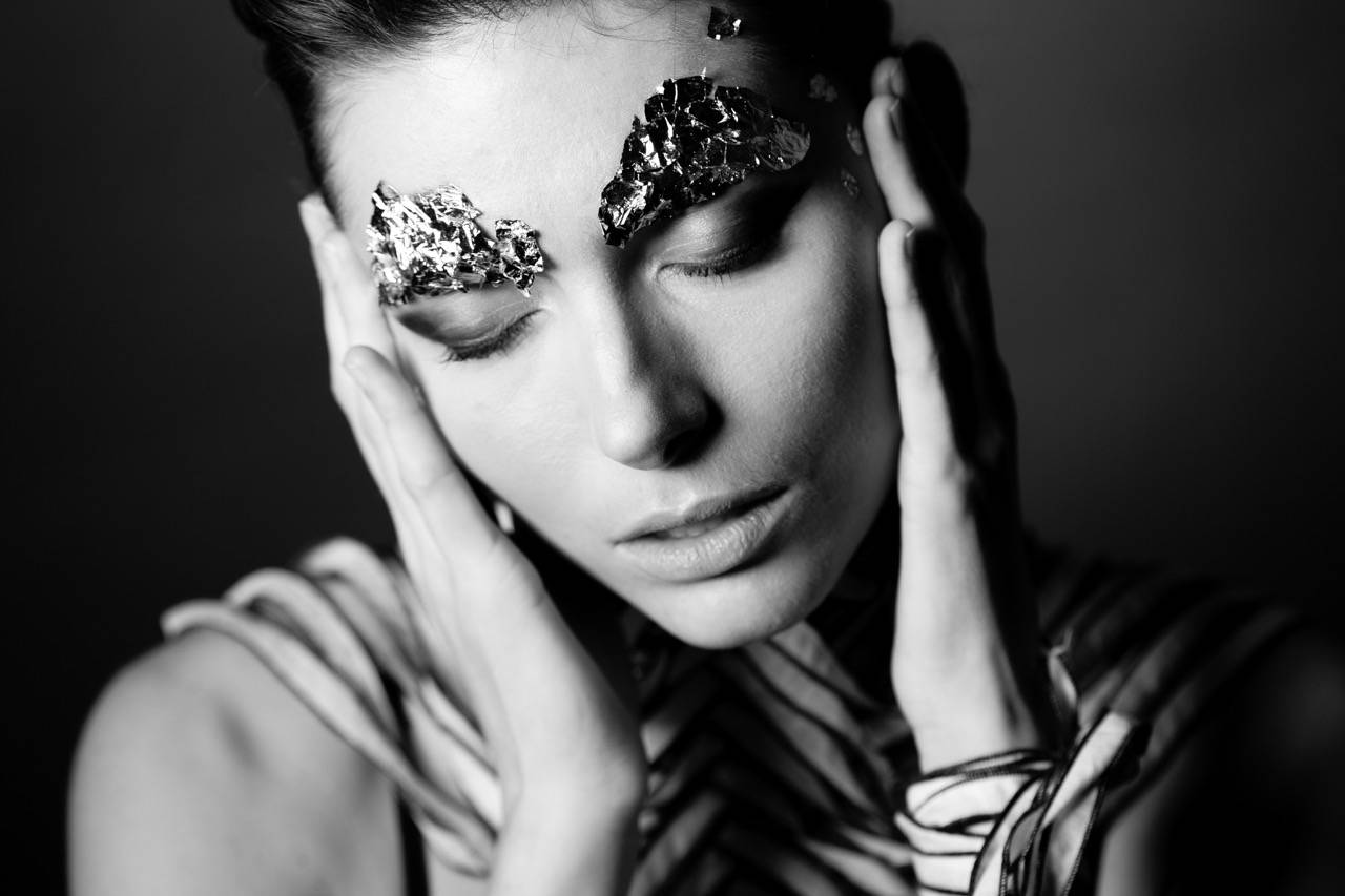 image created by artist Emily Mamone in her Timbre of Darkness series of a girl with hands on her cheeks.