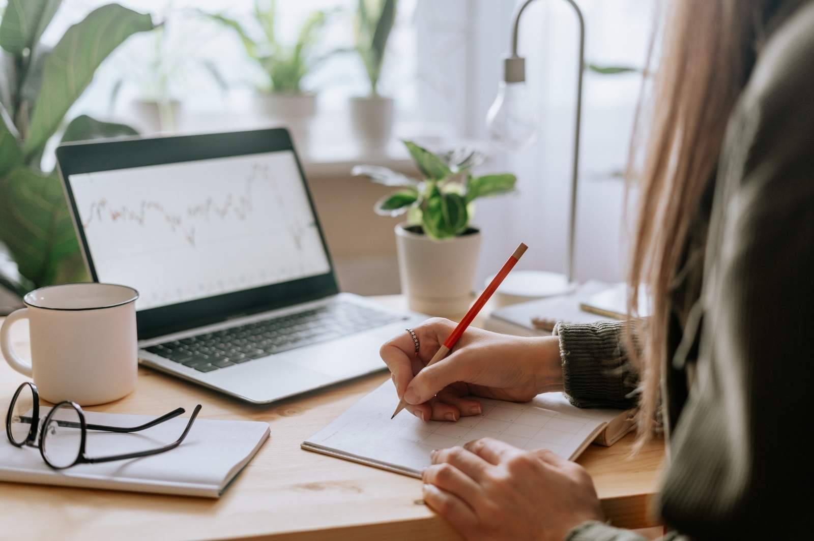 The image shows a laptop on a desk in front of a big window. The purpose of the image in to illustrate my sharing of thoughts on the success of my last email campaign revenue.