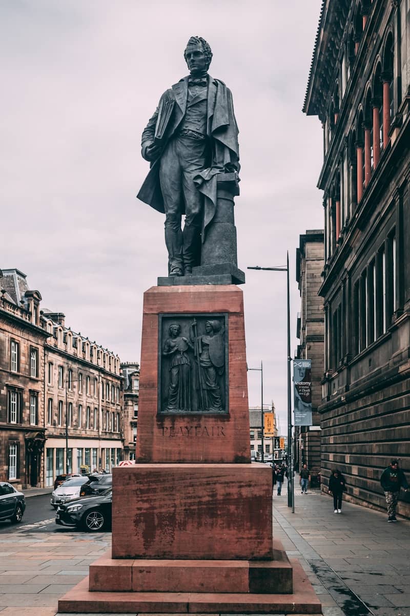 a statue of a person holding a gun on a street