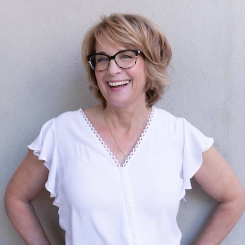 Image of Jennifer Crosswhite in a white blouse standing against a wall