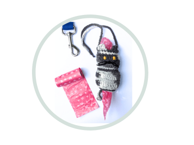 Crocheted cat holder for dog poop baggies, with bag and leash shown