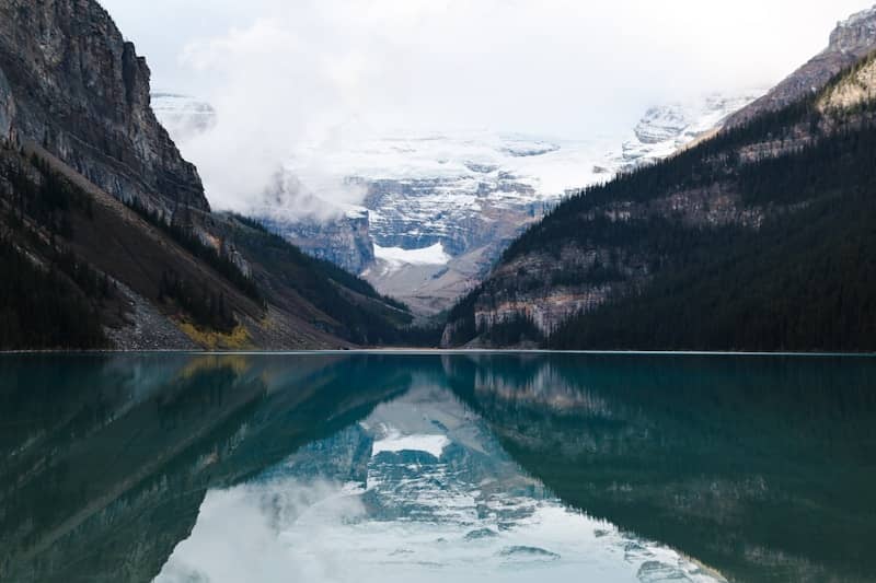 A body of water with mountains in the background