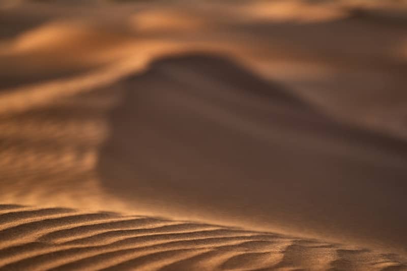 A blurry photo of sand dunes in the desert