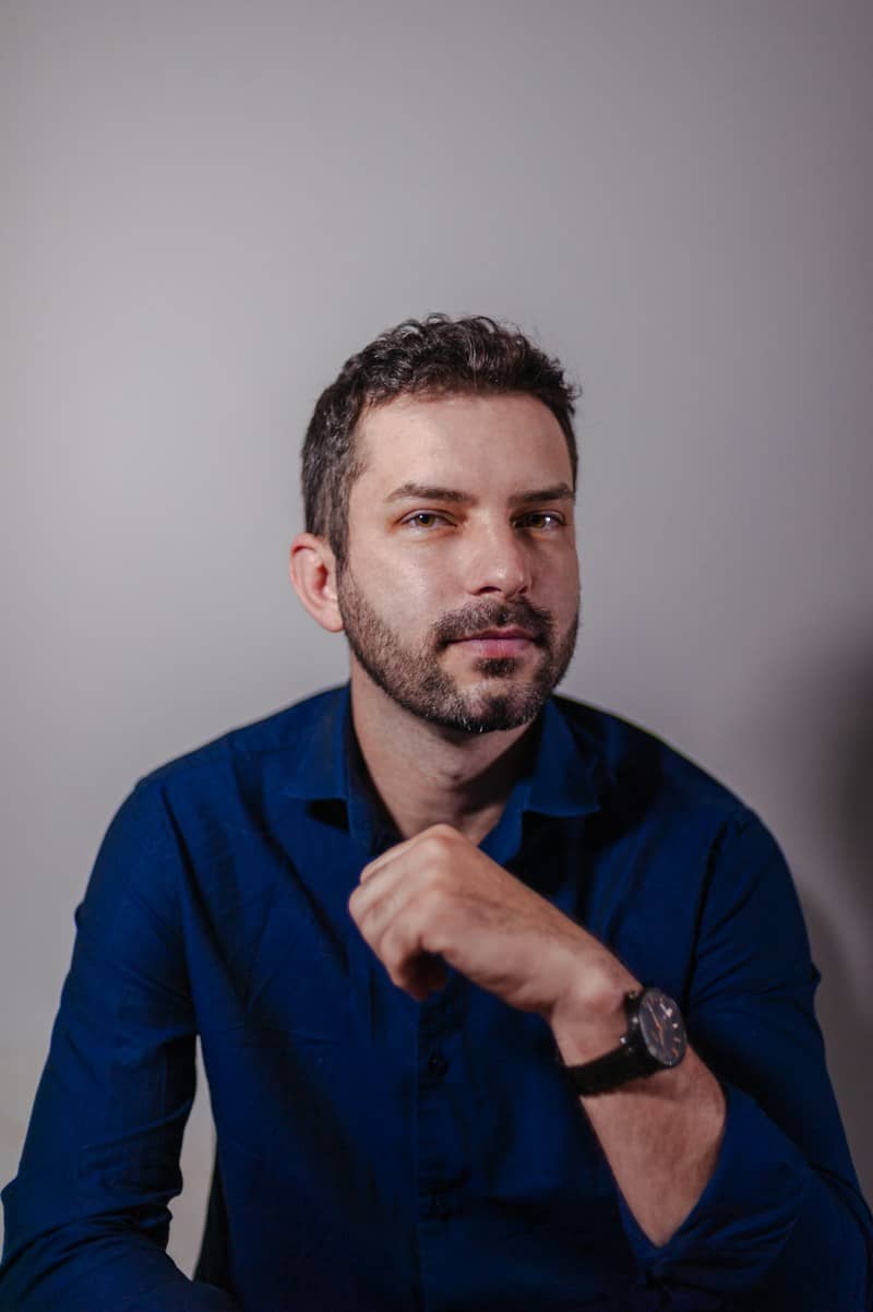 Man with beard and blue shirt looking directly forward.