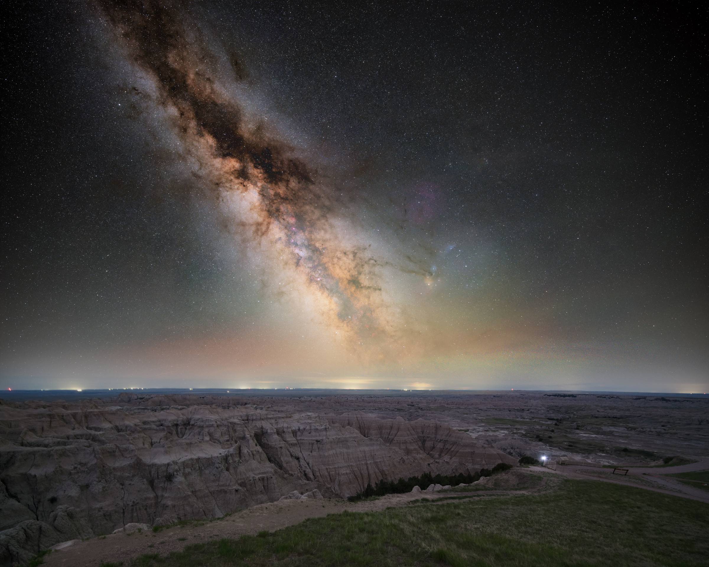 the milky way filling the sky over the landscape of Badlands National Park
